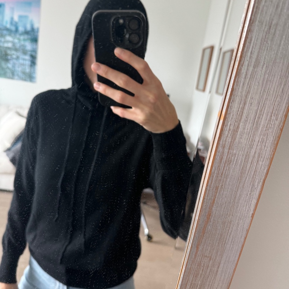 Black hooded sweatshirt/sweater.